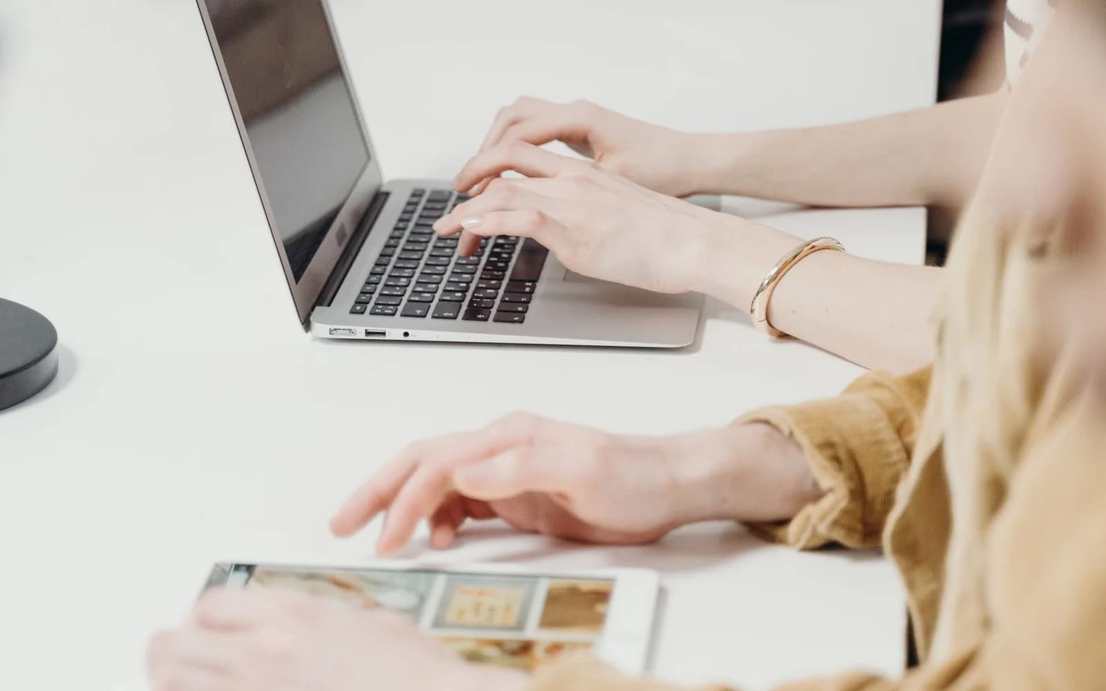 Editorial photograph: People Using a Laptop and a Tablet