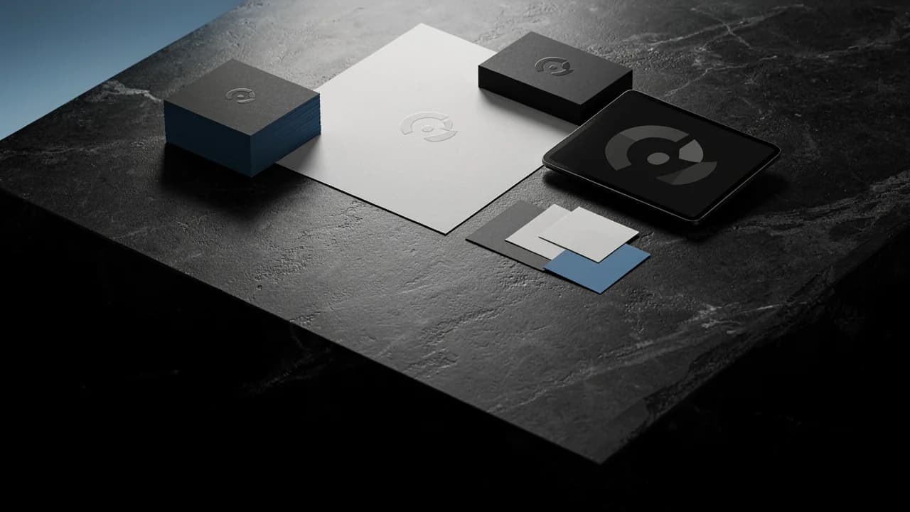 A VITON13 identity set on a black shelf: a card, a notebook, a silver pen and an emblem disc