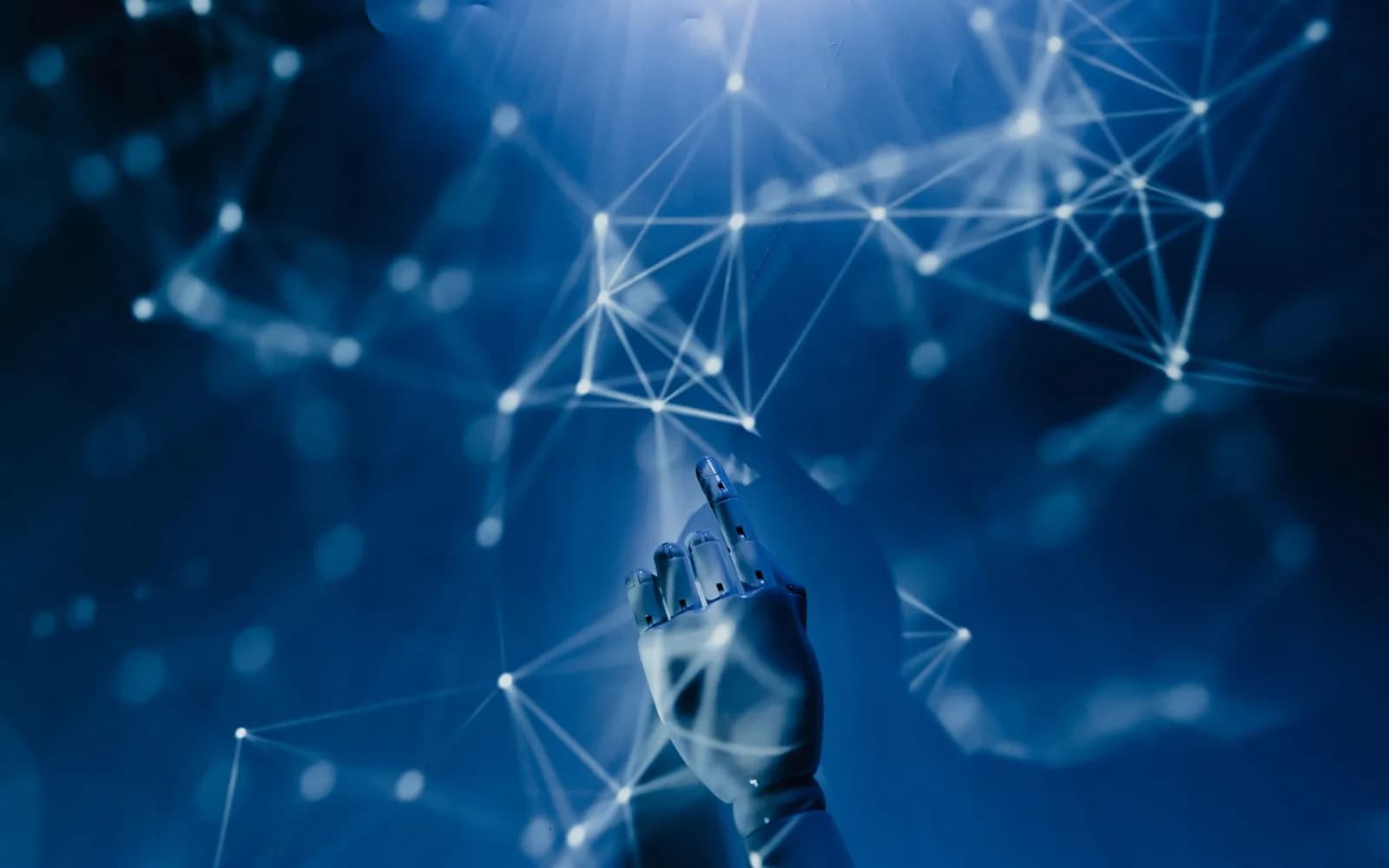 A robotic hand reaching towards a glowing network of connected points on a blue background