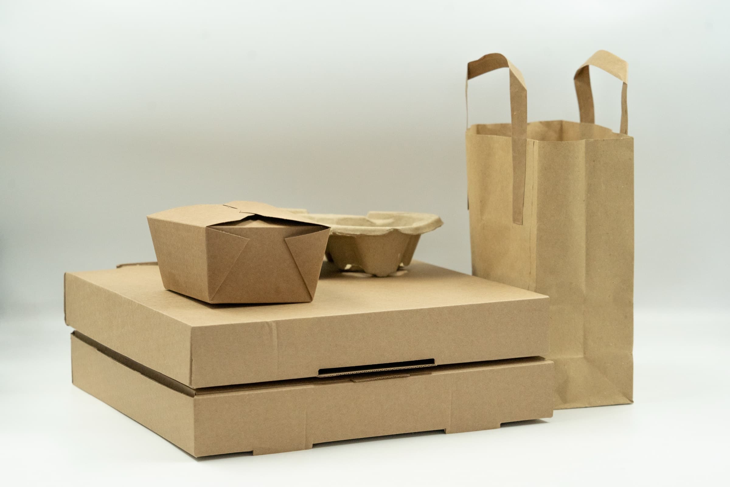 Kraft boxes and a paper bag on a light ground