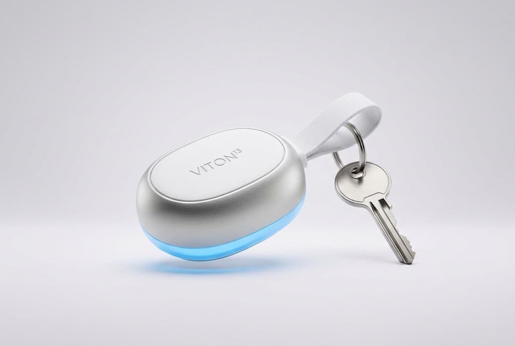 A rounded silver VITON13 key fob with a white strap and a key